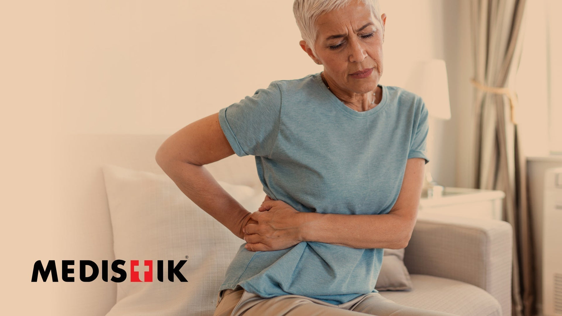 Person holding lower back or pelvis — expert advice on sacroiliac joint (SI joint) pain relief and treatment.