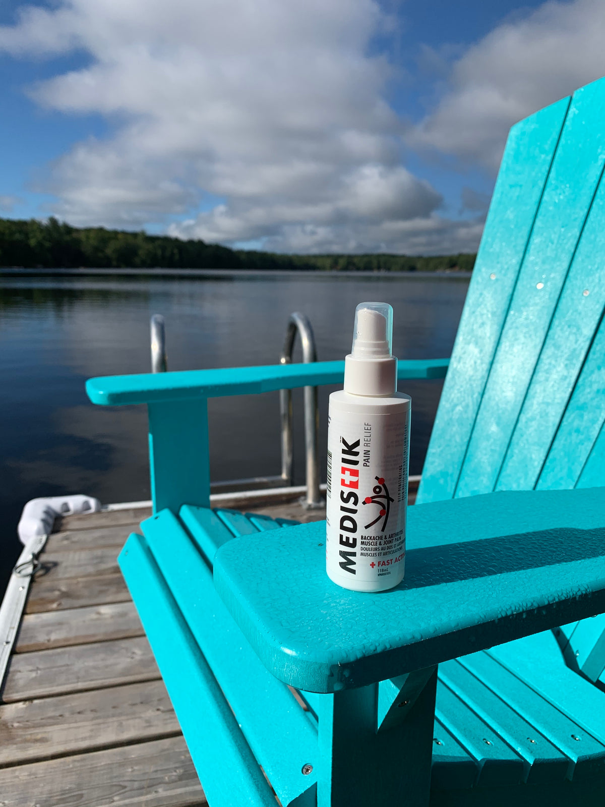 The MEDISTIK spray on a dock chair by a lake