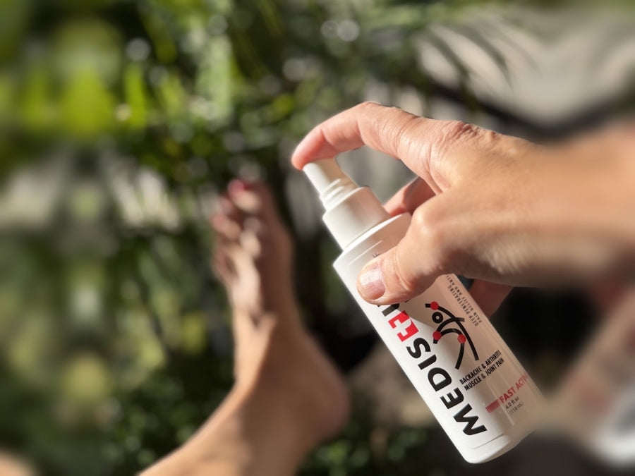 A hand using the MEDISTIK Power Spray outdoors