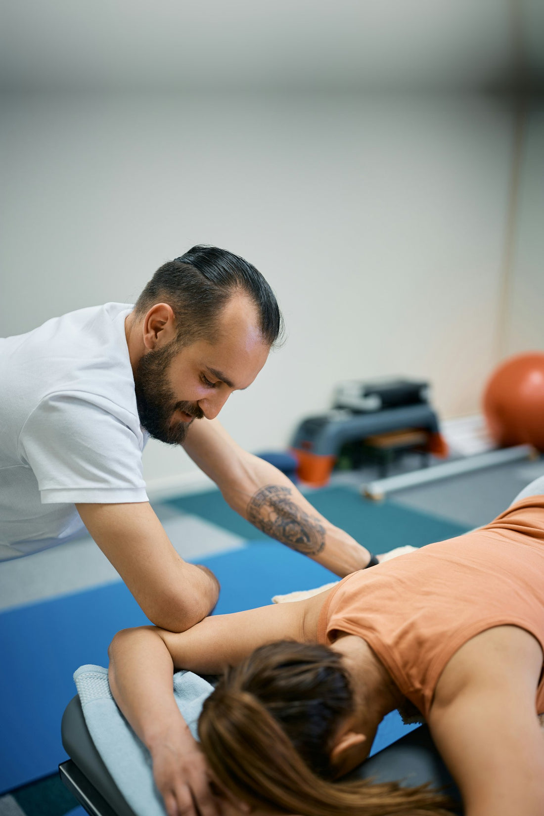 Physiotherapist treating a patient's shoulder and upper back