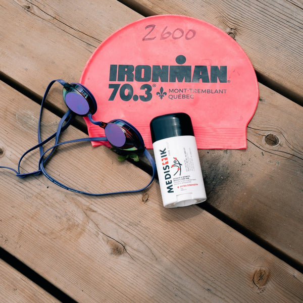 The Power Stick with an Ironman swim cap and goggles