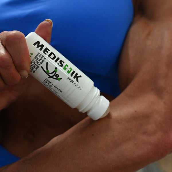 Applying the Daily Defense Roll-On to a forearm at the gym