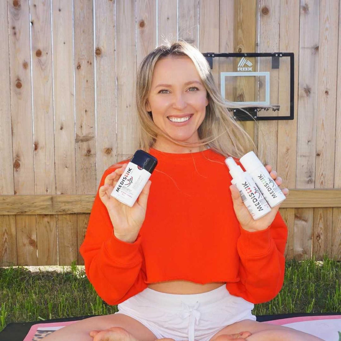 A woman sitting outdoors holding the Power Trio