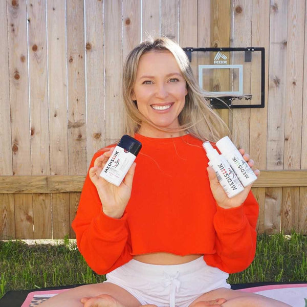 A woman holding the Power Trio on a yoga mat