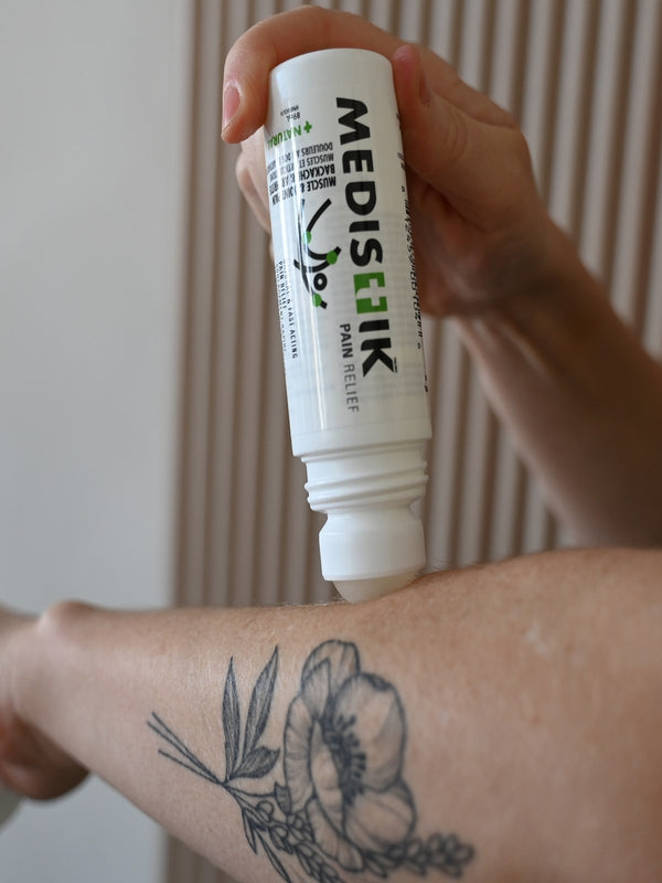 Applying the Daily Defense Roll-On to a tattooed arm