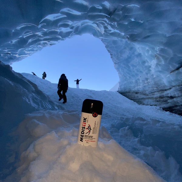 The Power Stick in the snow at the mouth of an ice cave